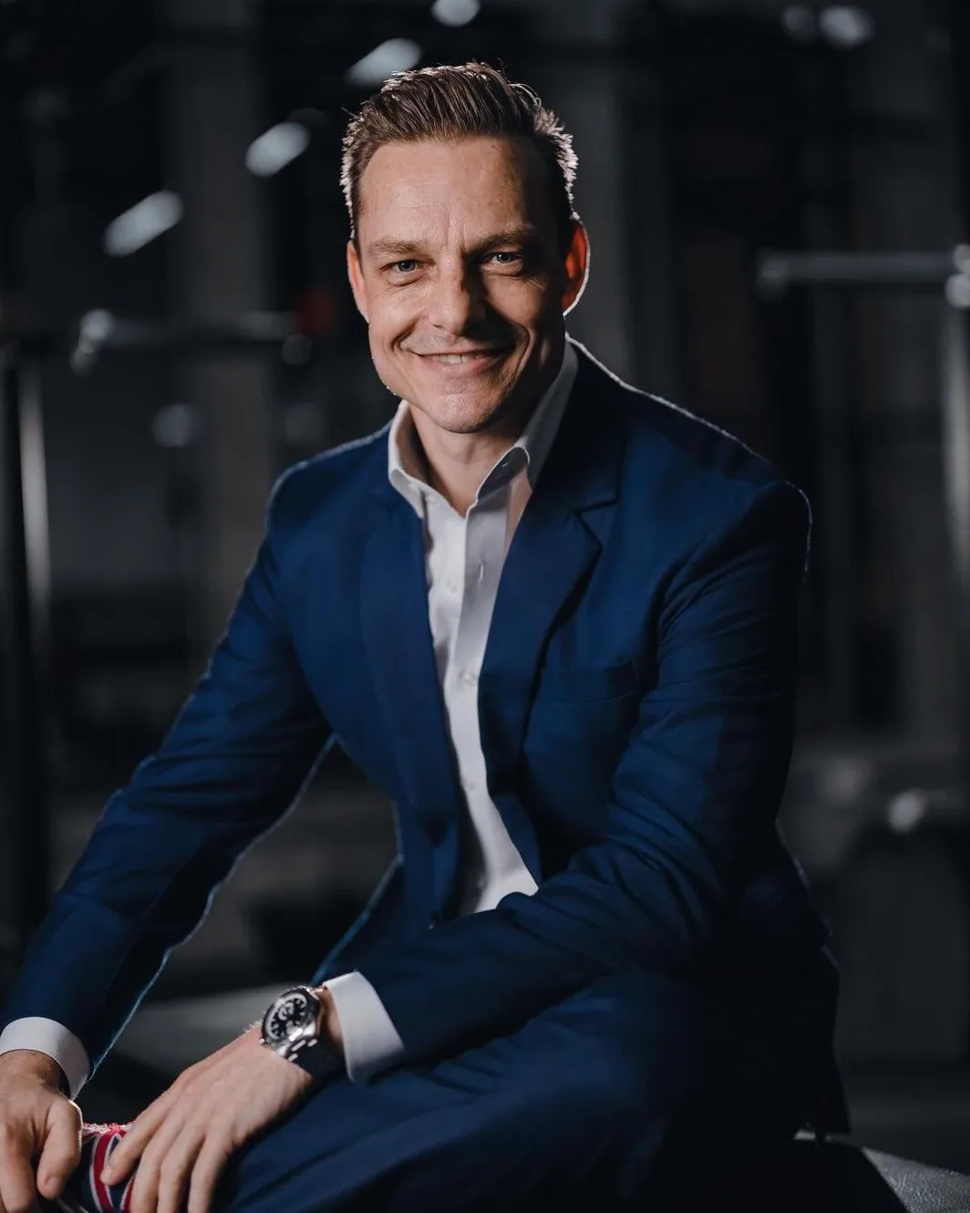 Dan Remon in a navy suit, seated